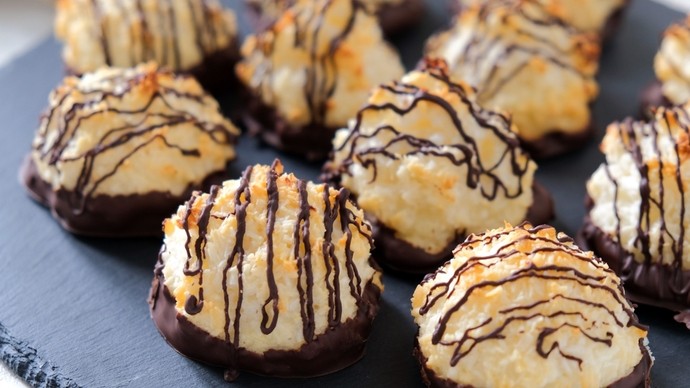 Crunchy circular homemade macaroons drizzled with dark chocolate