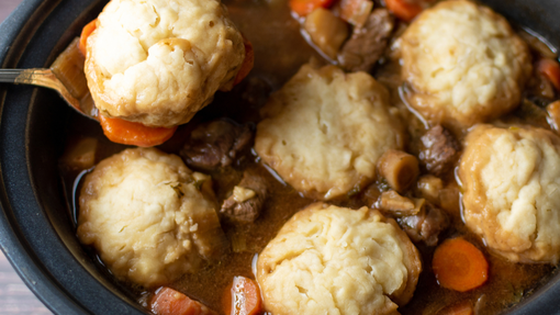 beef stew in a pot with dumplings