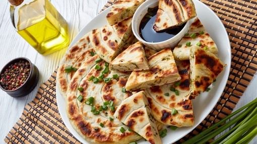 thick cut pancakes mixed with spring onion and topped with more spring onion pieces