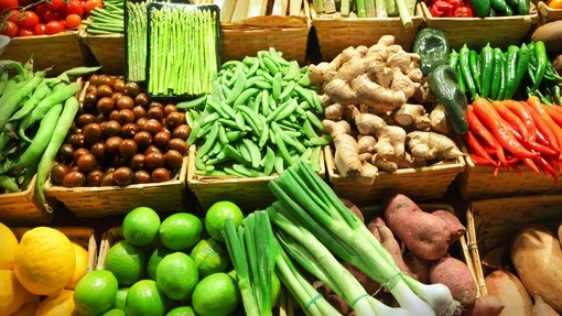 lots of fresh vegetables laid out at a market stall