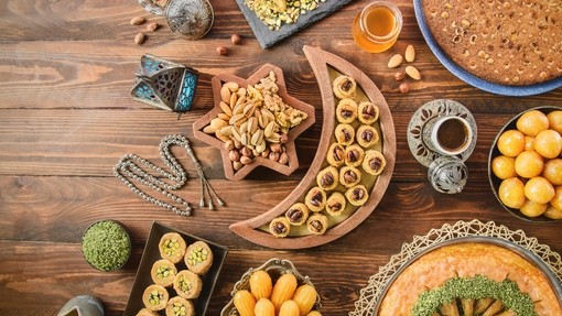 A wooden table with a spread of a variety of dishes.