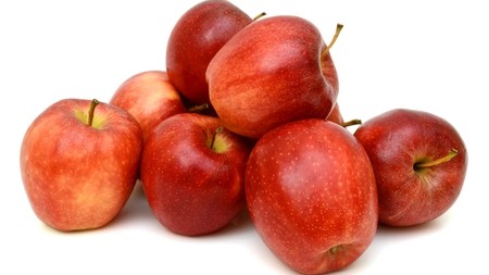a small pile of red apples
