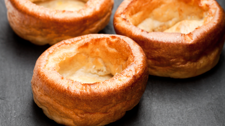 Three perfectly baked golden Yorkshire puddings