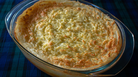 A mashed potato topped baked pie filled with haggis