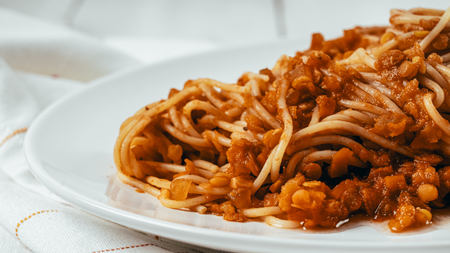 A delicious pile of lentils mixed with rich bolognese sauce