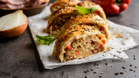 Sliced swirls of pastry rolls containing bacon and onion