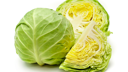 A round cabbage cut in half and a quarter