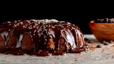 Bundt cake with chocolate sauce running down the top and sides