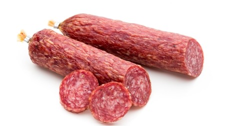 a salami cut in half with a couple of slices
