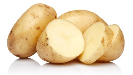 a small pile of raw unpeel potatoes
