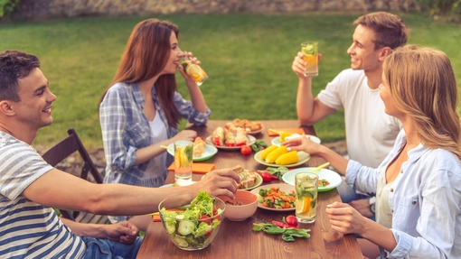 Group of younger people eating and chatting together